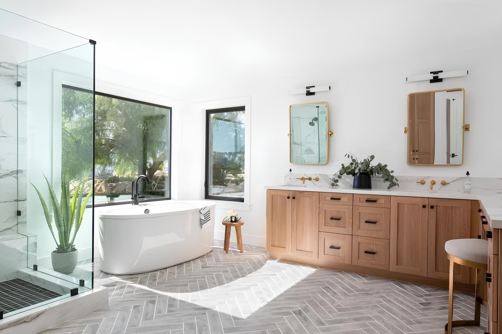 Custom bathroom featuring double vanity, large windows, glass walk-in shower, and free standing bathtub Metzler Construction