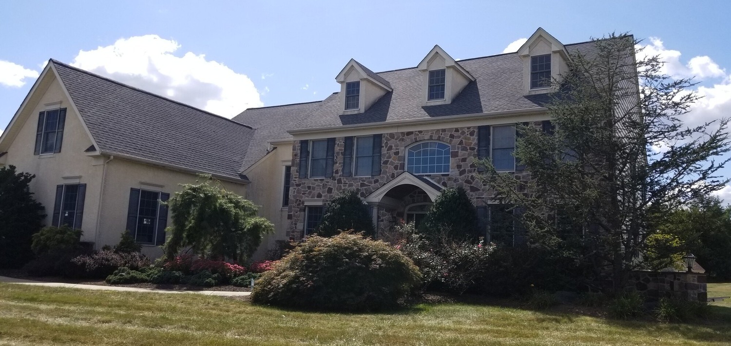 Exterior renovation project with stucco and stone siding in Bucks County