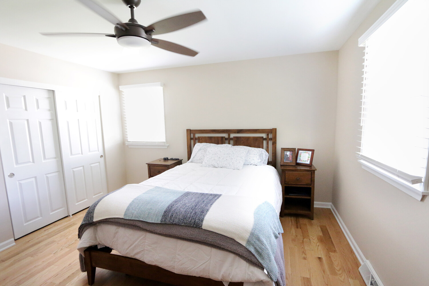 Renovated bedroom with new ceiling fan and hardwood flooring in Perkasie, PA custom home by Metzler Construction