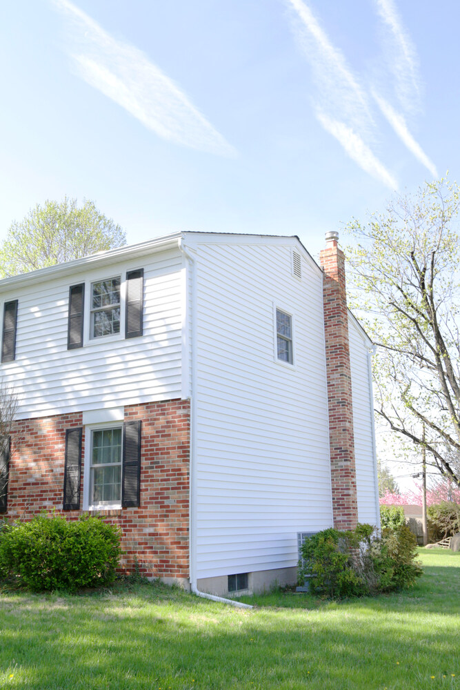Side view of completed siding restoration on a custom home in Perkasie, PA by Metzler Construction