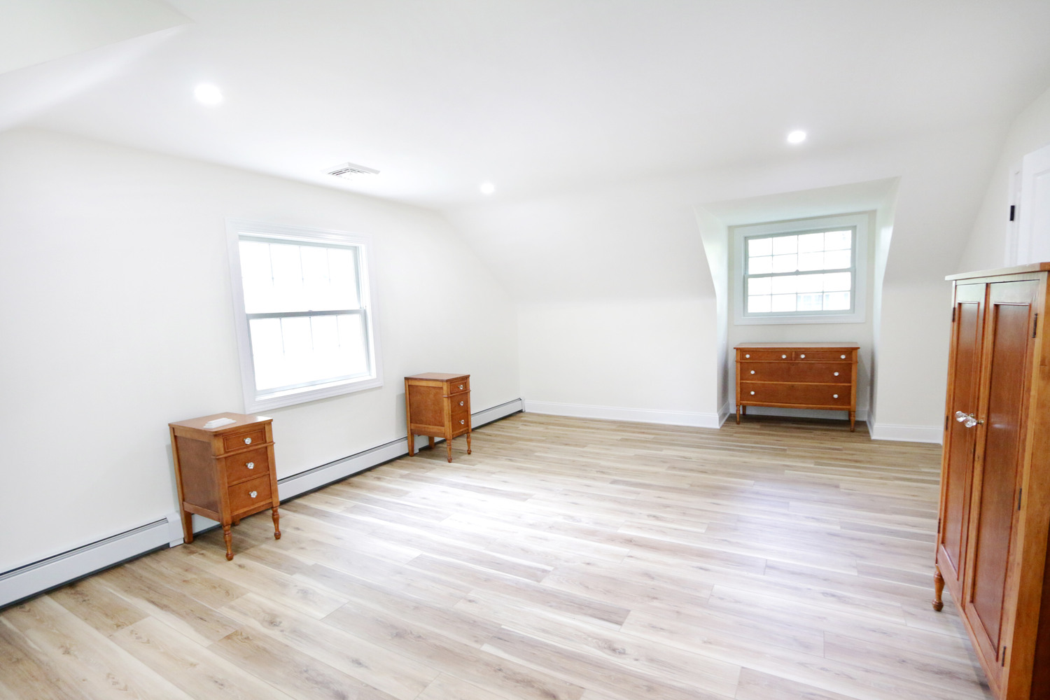 Renovated upstairs bedroom with wood floors and dormer windows in Perkasie, PA by Metzler Construction