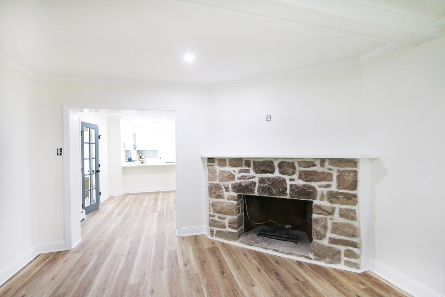 Stone fireplace feature wall in living room remodel by Metzler Construction in Perkasie, PA
