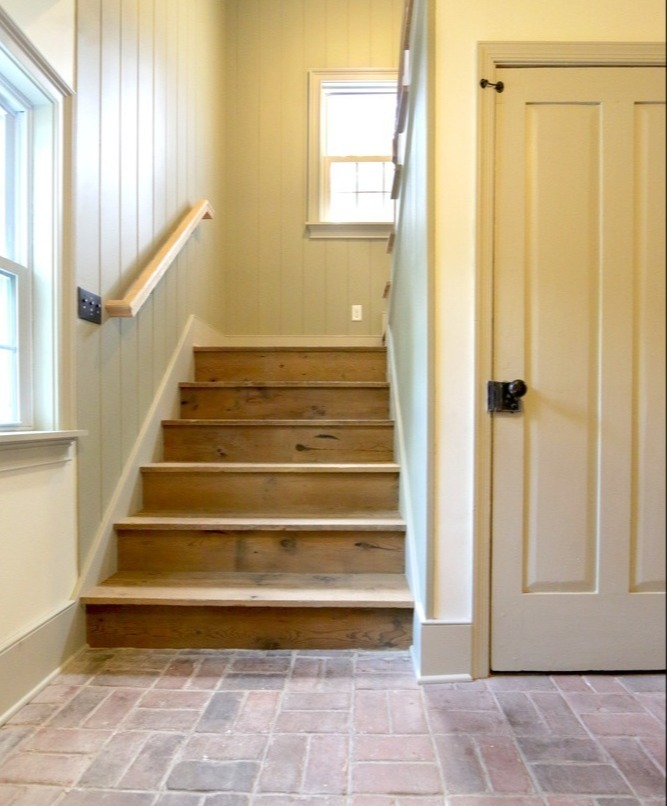 Entryway staircase remodel with natural wood treads and brick flooring by Metzler Construction in Perkasie, PA-1