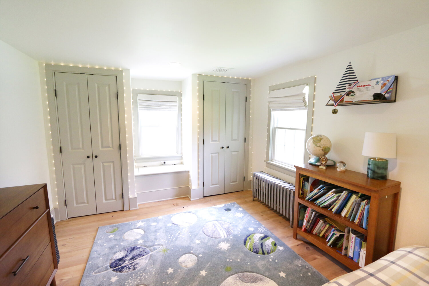 Kids’ bedroom renovation with space-themed rug and built-in closets by Metzler Construction in Perkasie, PA