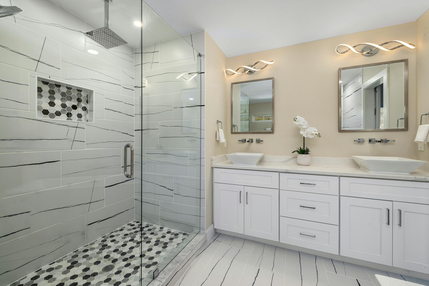 Custom walk-in shower with patterned tile and dual vanity by Metzler Construction in Perkasie, PA - Stock Image