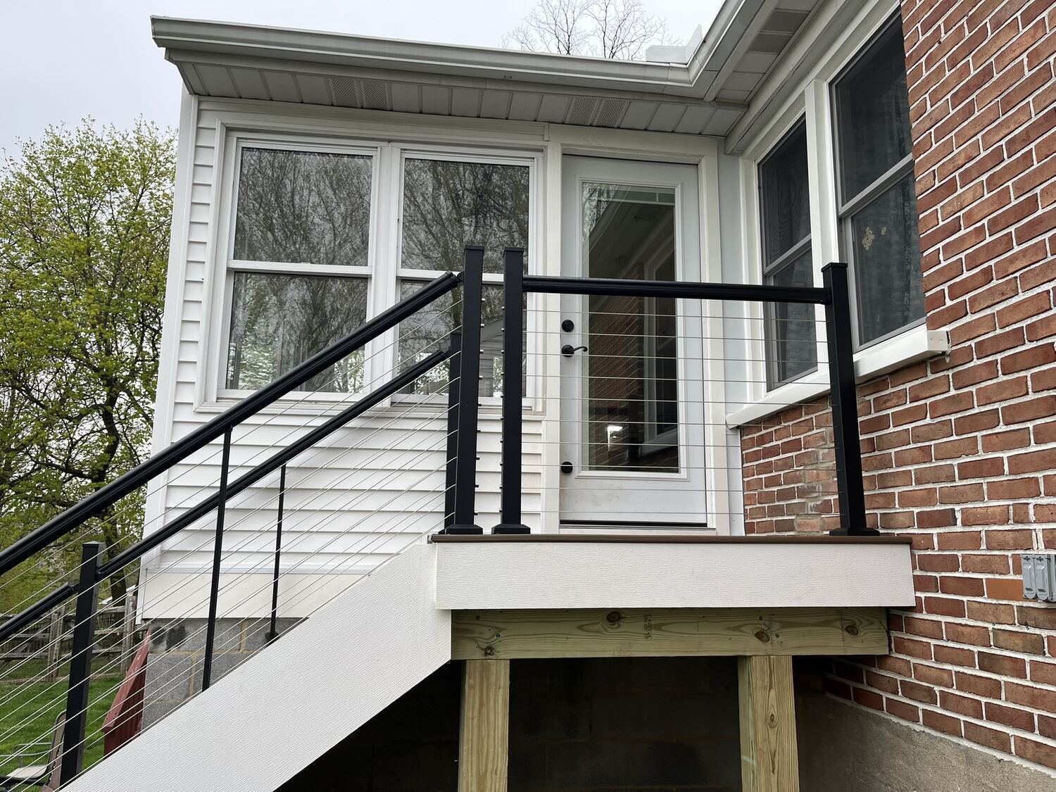 White stairs and black railing leading to a sunroom in Montgomery County
