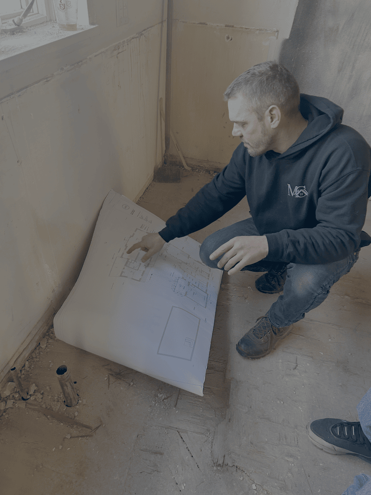 Metzler employee reviews a blueprint for a home remodel