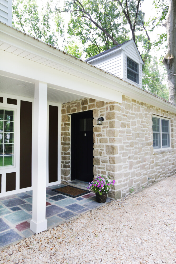 Custom home entryway with stone exterior and fresh landscaping in Perkasie, PA by Metzler Construction