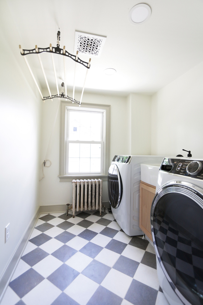 Custom laundry room renovation with checkerboard tile flooring by Metzler Construction in Perkasie, PA