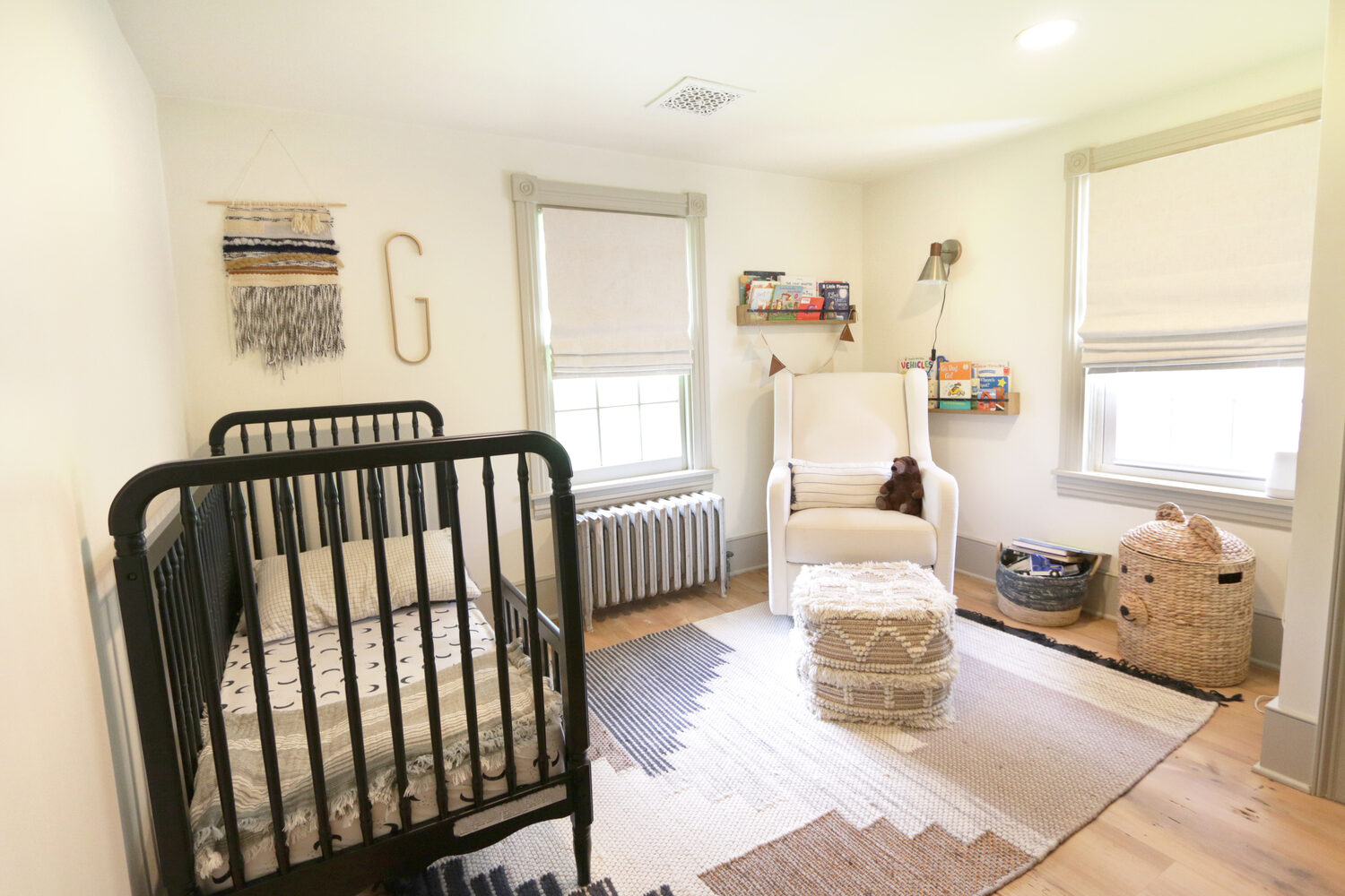 Nursery room remodel with crib, soft lighting, and cozy textures by Metzler Construction in Perkasie, PA