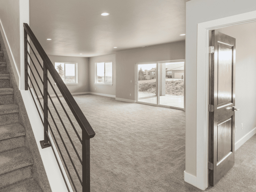 Open layout basement with sliding door access in a Perkasie custom home by Metzler Construction - Stock Image