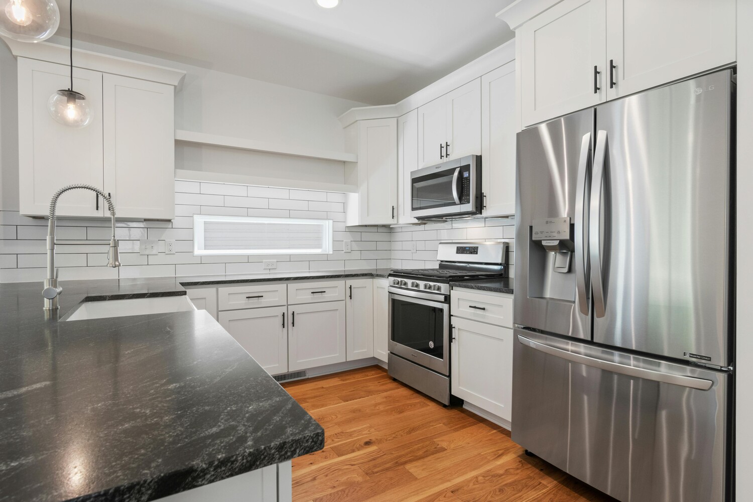 Renovated kitchen with stainless steel appliances in Metzler Construction project in Perkasie, PA - Stock Image