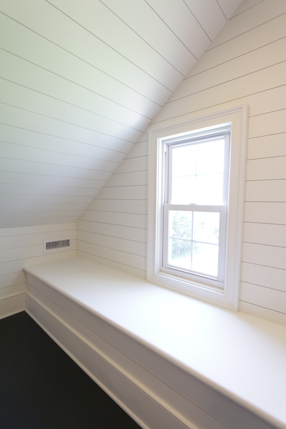 White shiplap on wall and ceiling in attic space by Metzler Construction